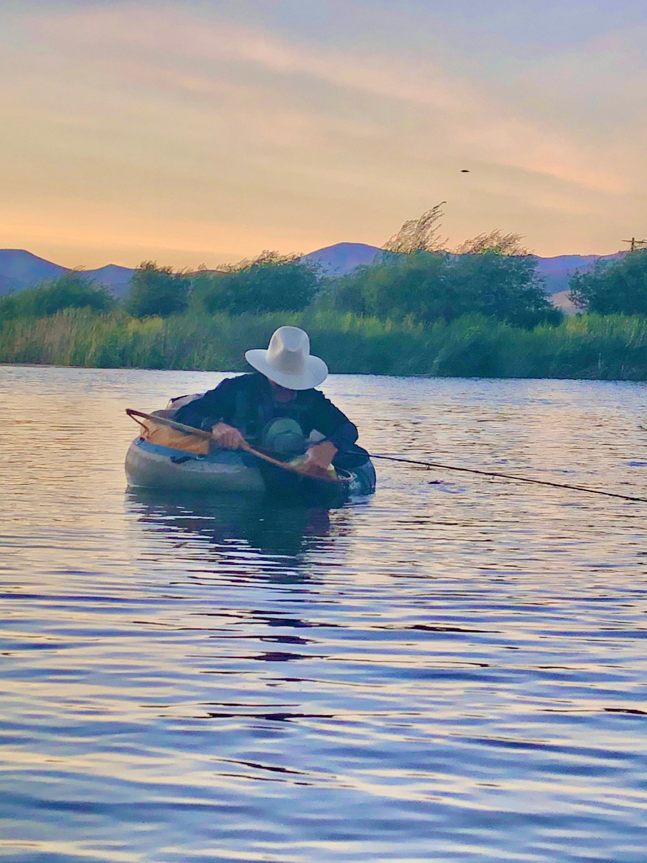 Russ Lamb fly fishing from a float tube at dusk