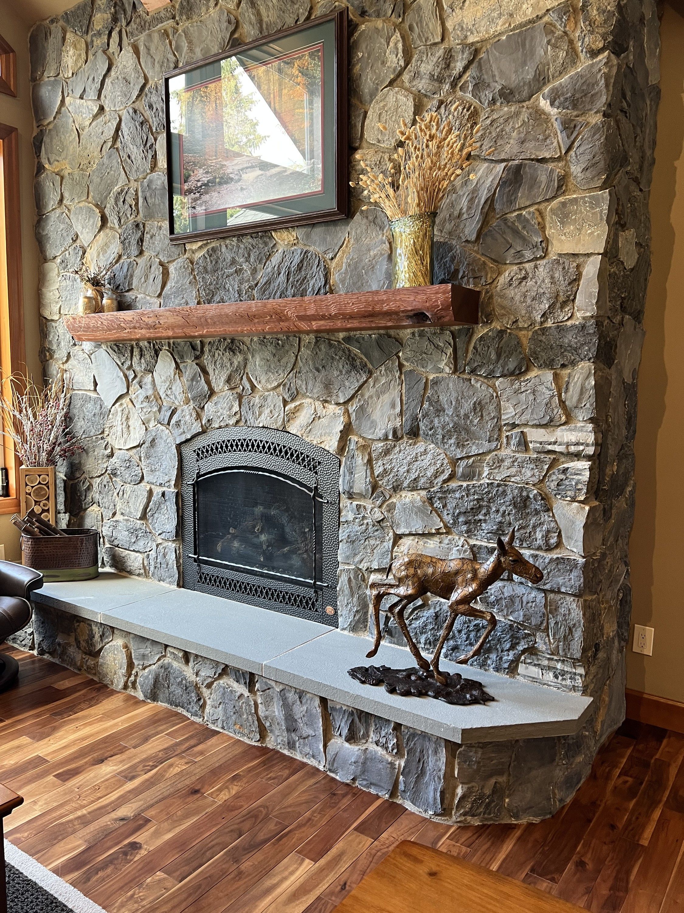 The Pointed Down Baby Moose installed on a stone fireplace hearth