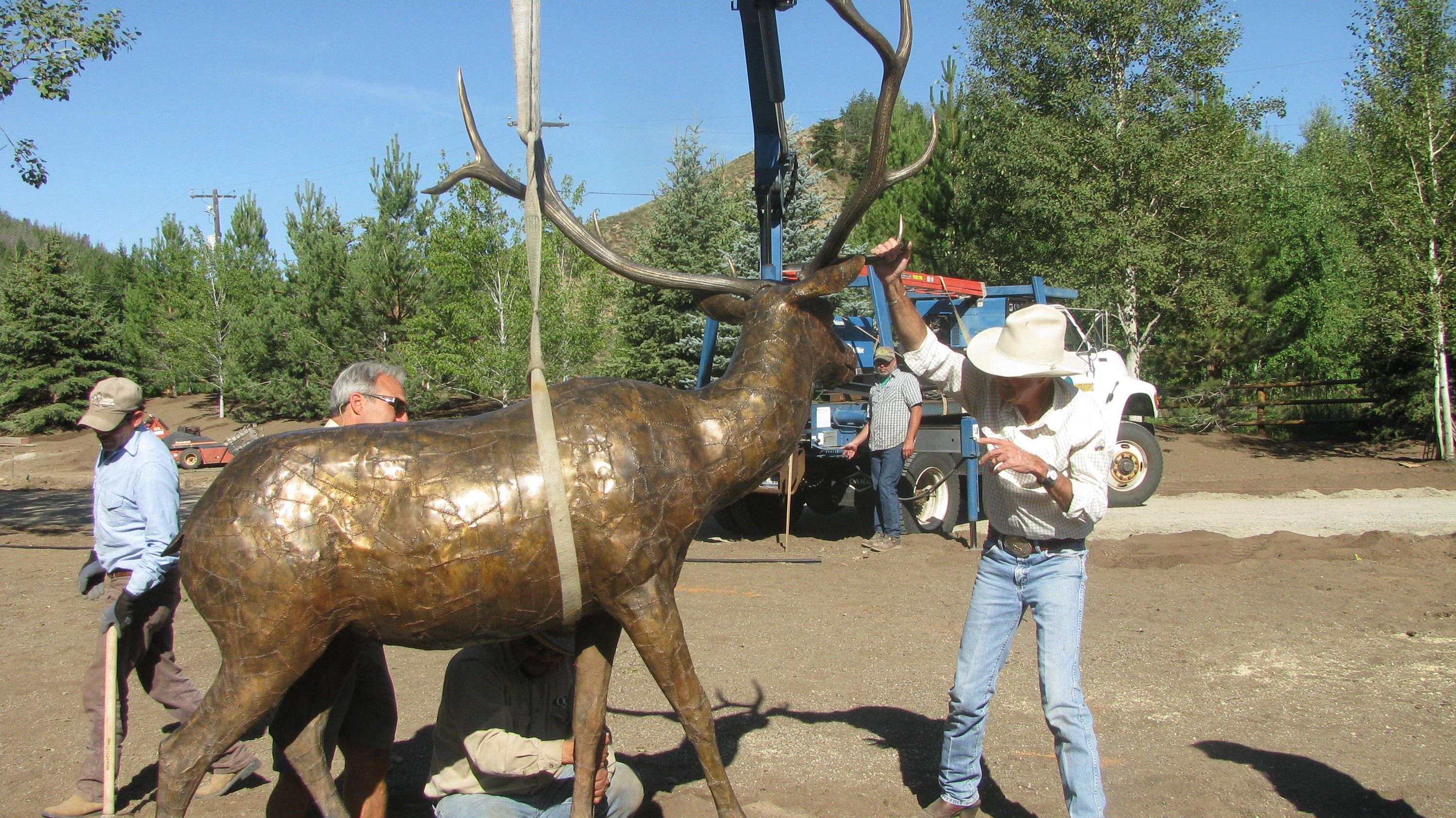 The third casting of the bronze bull elk being lowered into place at its Sun Valley installation