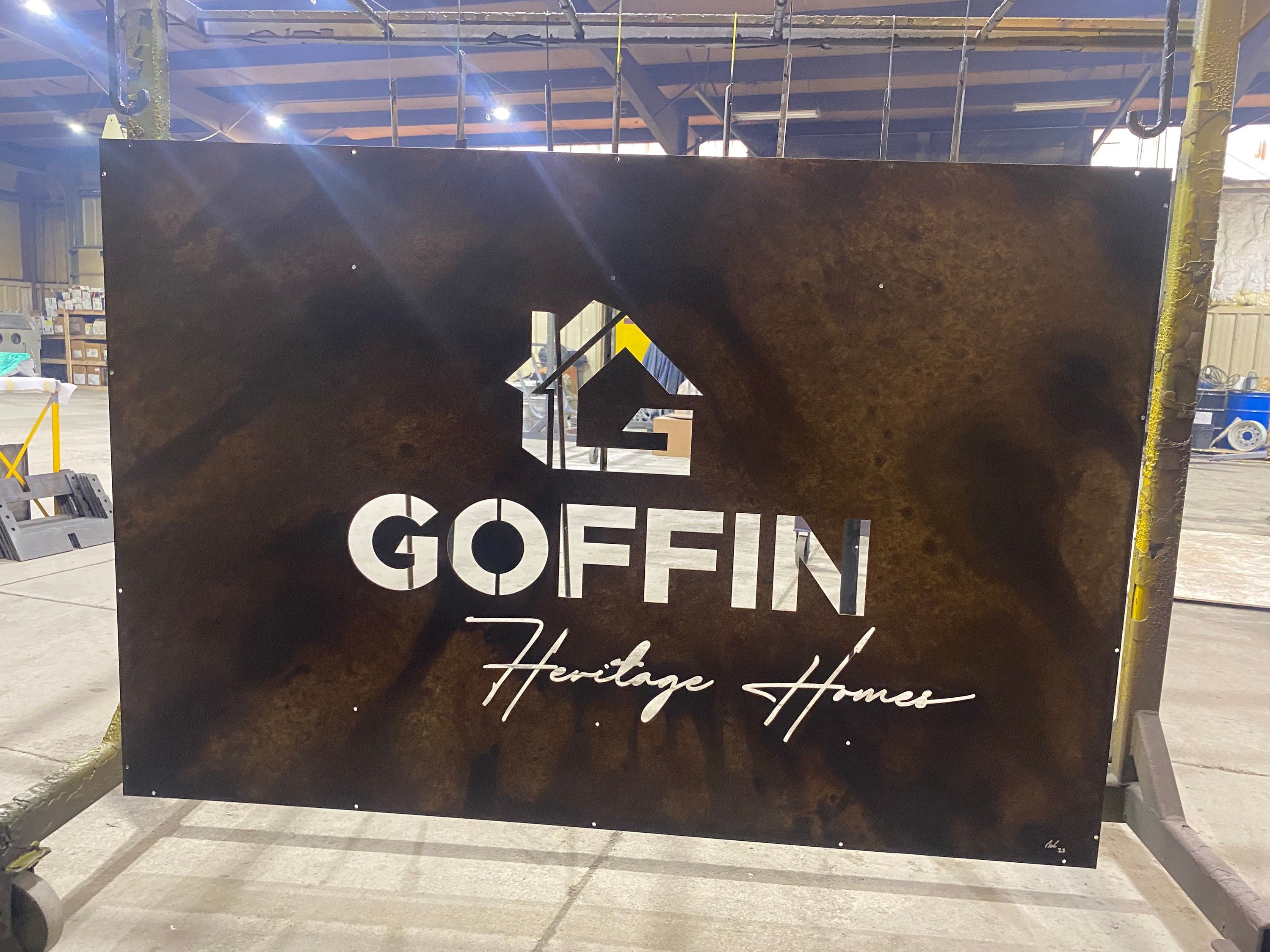 The patinaed Goffin panel hanging in the fabrication shop