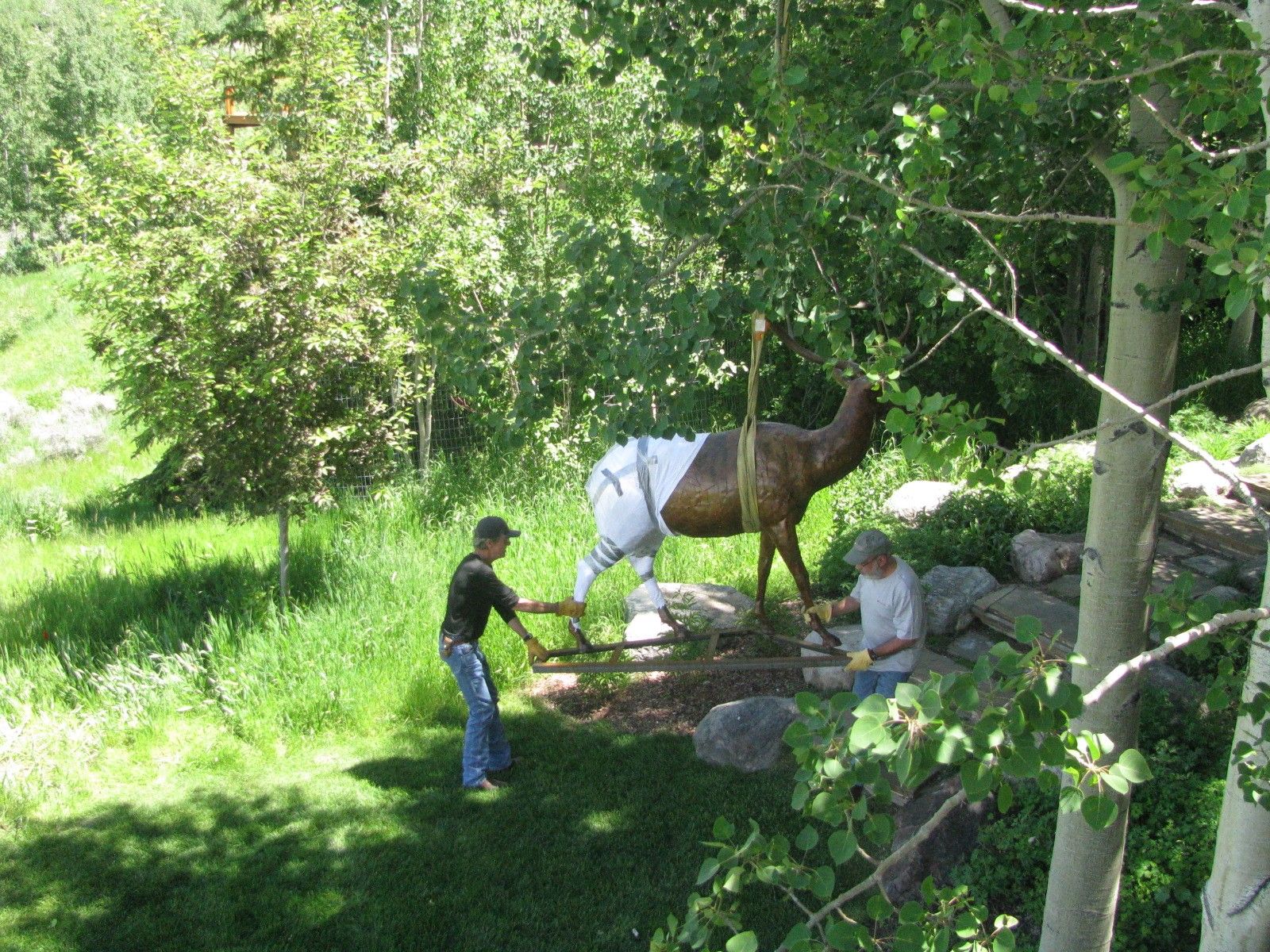 Carrying the wrapped elk down the stone steps